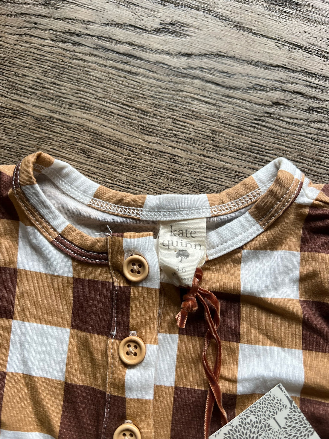 Kate Quinn Brown Onesie